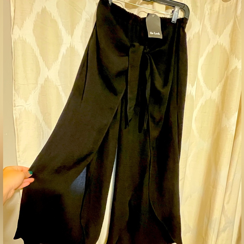 Black pants with slits in the front. Never worn